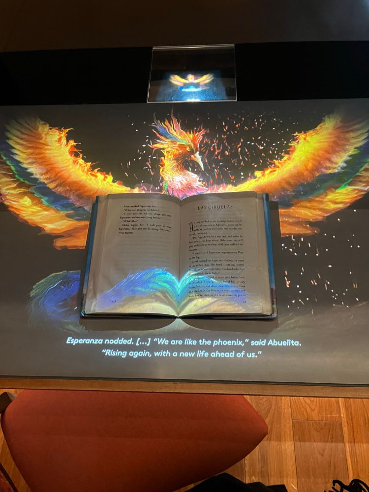 Photo of a phoenix rising around a copy of Esperanza Rising