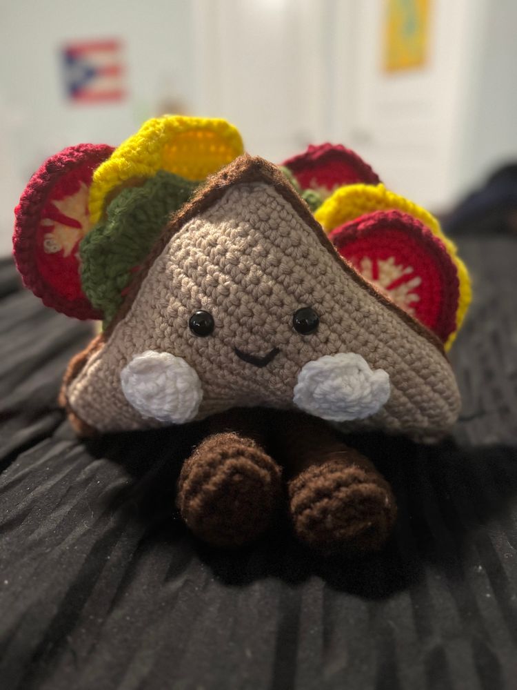 Photo of a happy little sandwich with little brown feeties. He has two slices of cheese, two pieces of lettuce, and three slices of tomato. 
