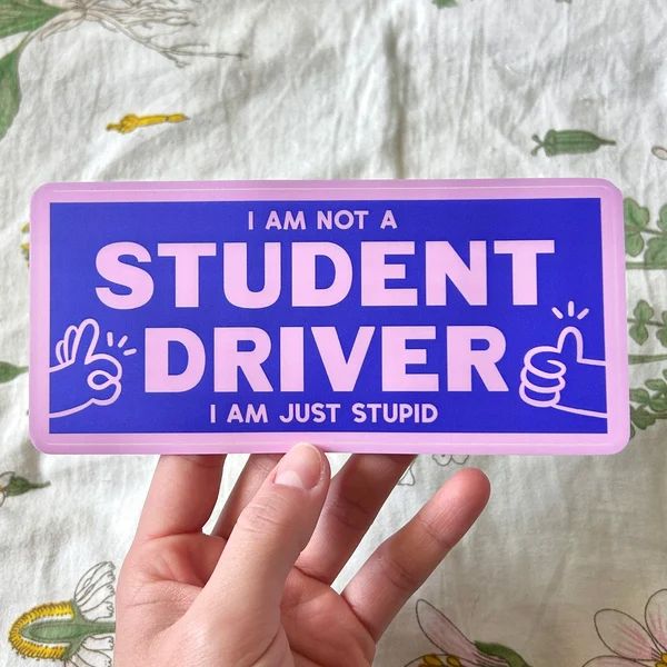Purple and pink bumper sticker with pink text that says, "I am not a student driver. I am just stupid."