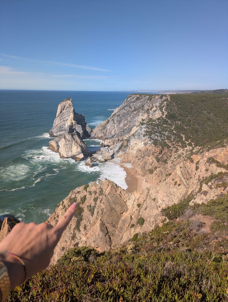 A view from the top of the cliffs onto a gorgeous wild beach I went to. In the bottom left corner of the photo my finger is pointing at where I'm headed ;)