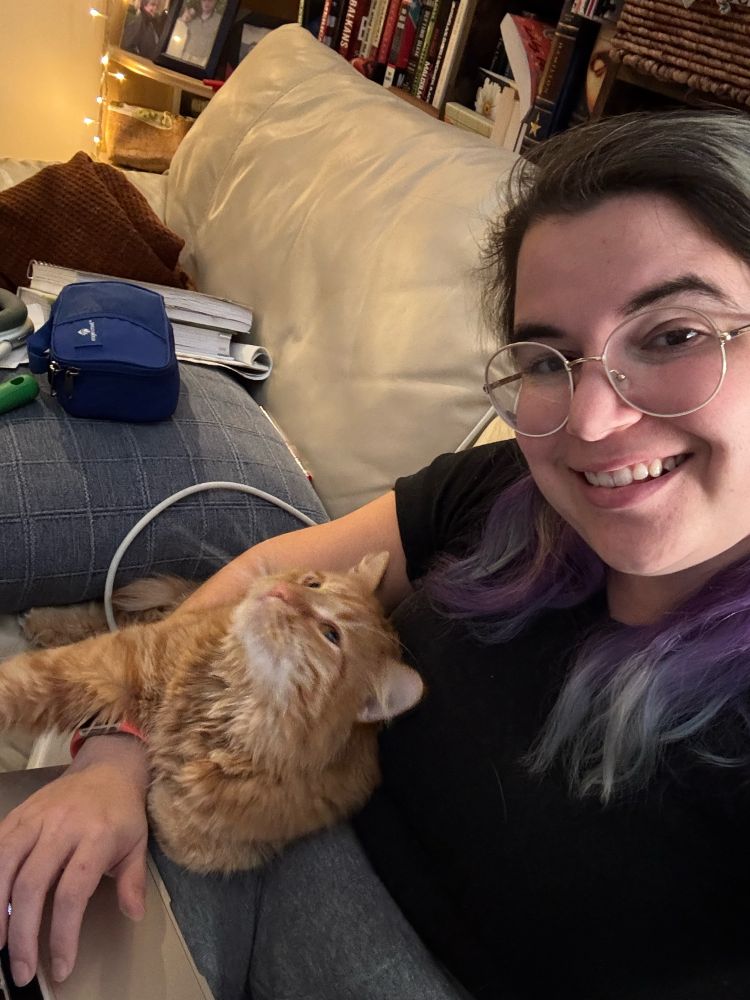 Beau (fluffy orange cat) tucked under my arm as I type and a selfie of me. 