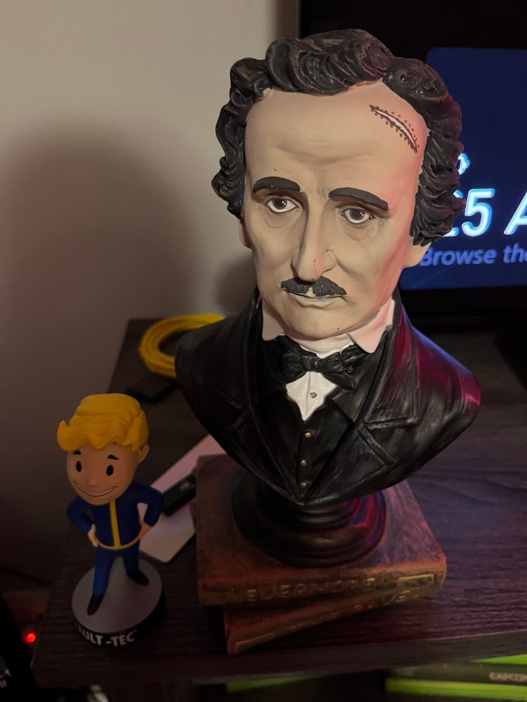 A bust of Edgar Allan Pos and a Fallout Vault Boy Bobblehead. Nevermore. 