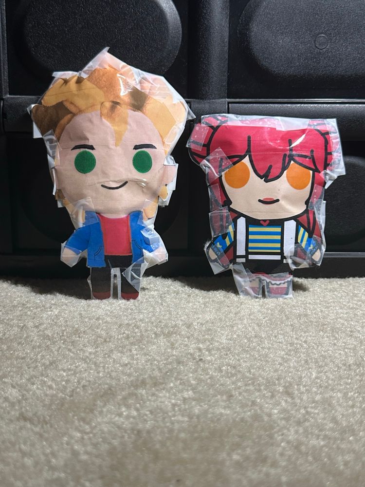 Stardew Valley Sam and Farmer Stella standing each other as paper plushies