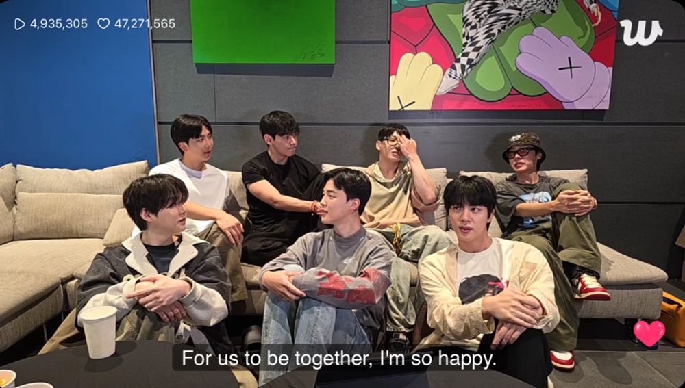 ot7 sitting around all together and the translated text at the bottom says “for us to be together, i’m so happy”