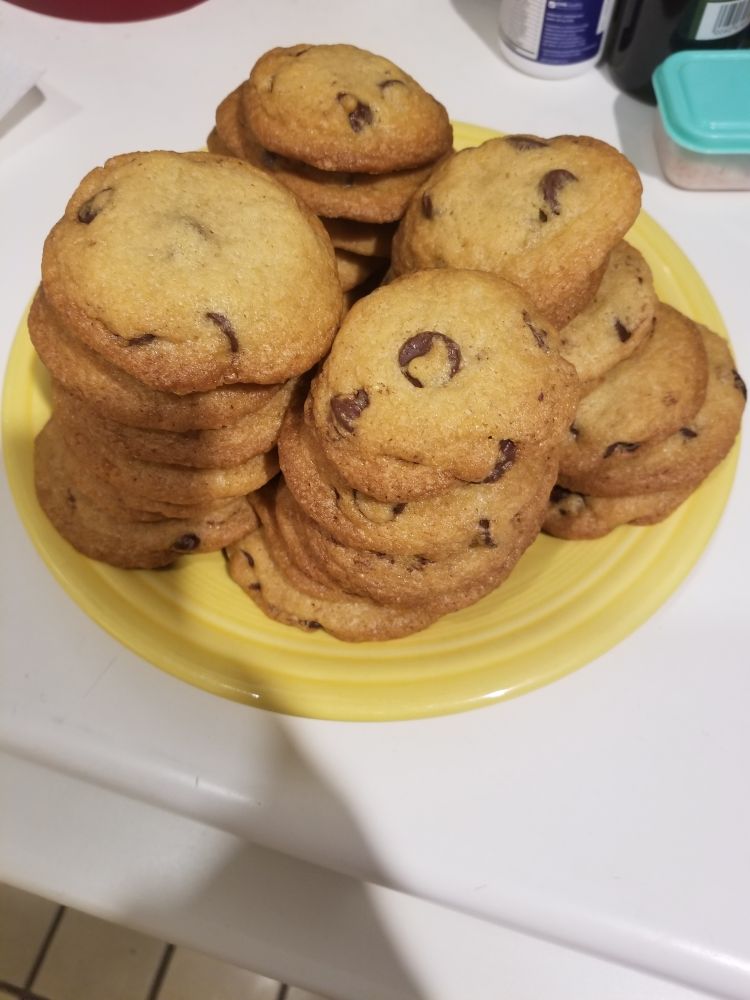 A large plate of homemade chocolate-chip cookies.