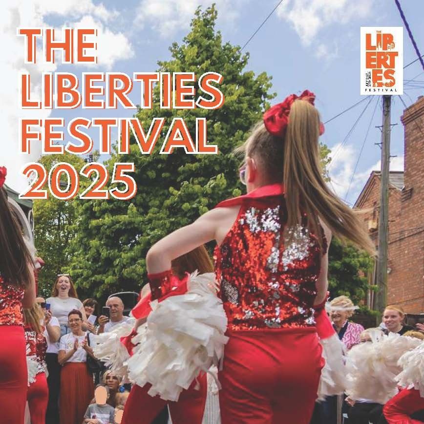 The cover of the Liberties Festival Brochure 2025, which is a photo of some young dancers in their red costumes with silver and red sequins and holding white cheerleader pom poms, as a group of people watch their dance moves and cheer them on.