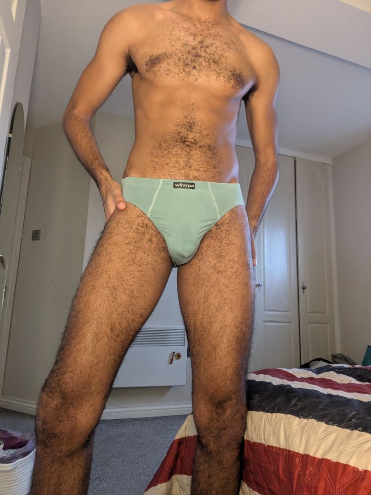 Me stood in my room wearing nothing but teal briefs. Bulge shows slight vpl.