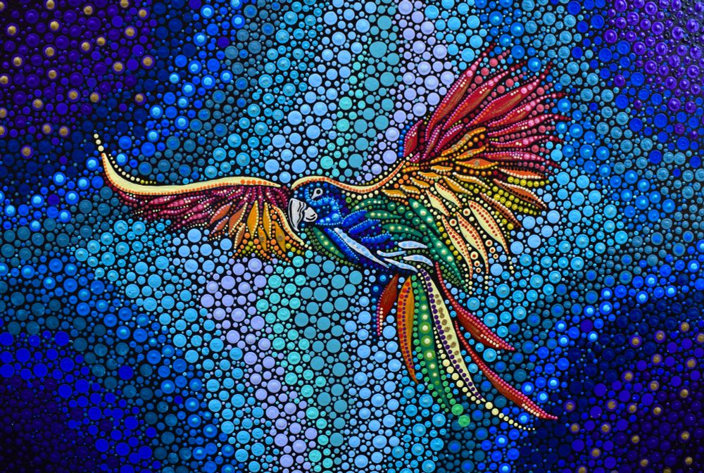A dot painting of a parrot in flight. It is multicoloured and flying left with its wings spread. The background is blue dots. 