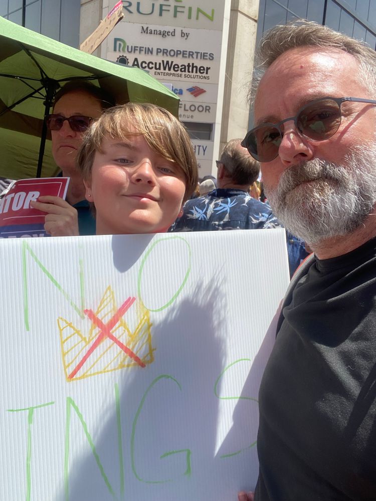 Man and son with no kings sign