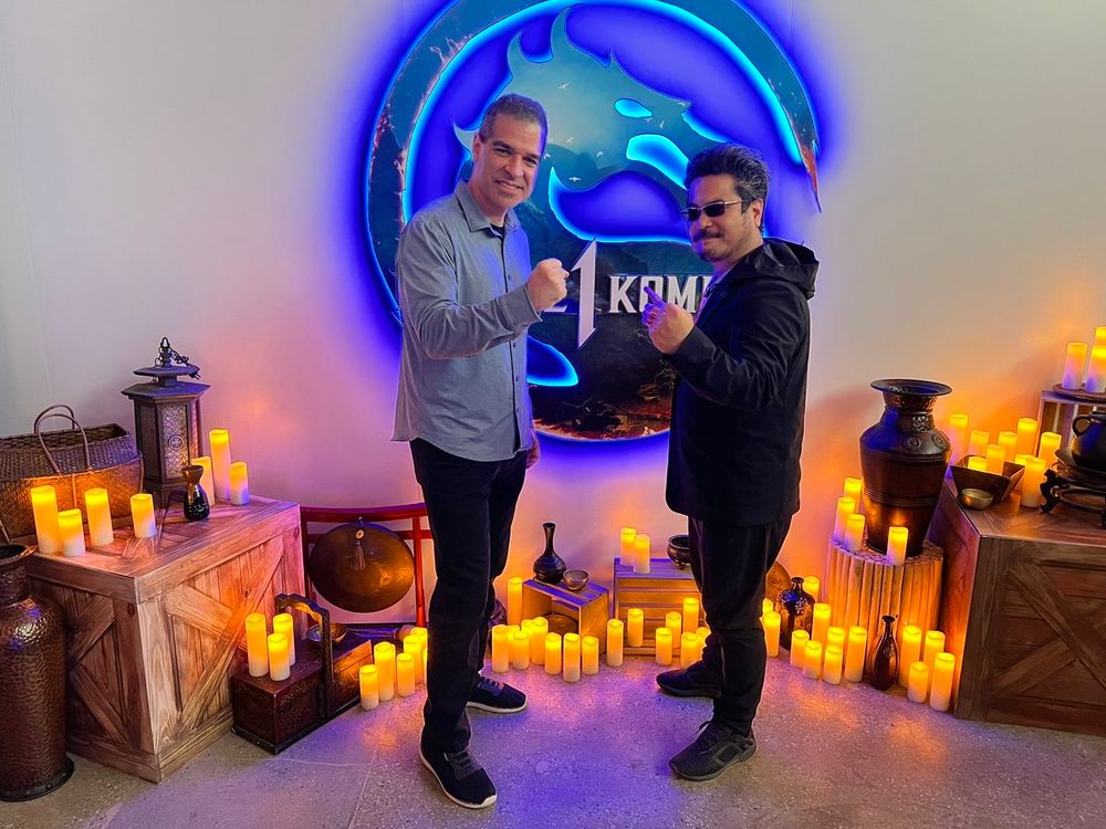 Ed Boon and Katsuhiro Harada in front of the Mortal Kombat 1 logo