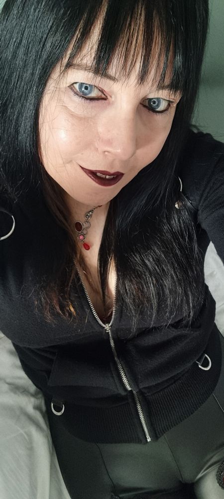 A selfie of me. I've got plastic pleather leggings on, a black zip up hoodie with the zip down enough to show some cleavage. My straight black hair is long enough to just sit on my boobs. I'm looking up at the camera with the best come to bed eyes a knackered fifty something lass can muster, let me know if that works on you. Darkest red lippy because I tried black first but didn't like it today and switched to red