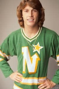 Andy Gibb in a green (away) Minnesota North Stars NHL sweater, circa late '70s/early '80s. The logo is a big white N with gold borders; the rightmost line of the N is an arrow pointing toward a 5-pointed gold star.