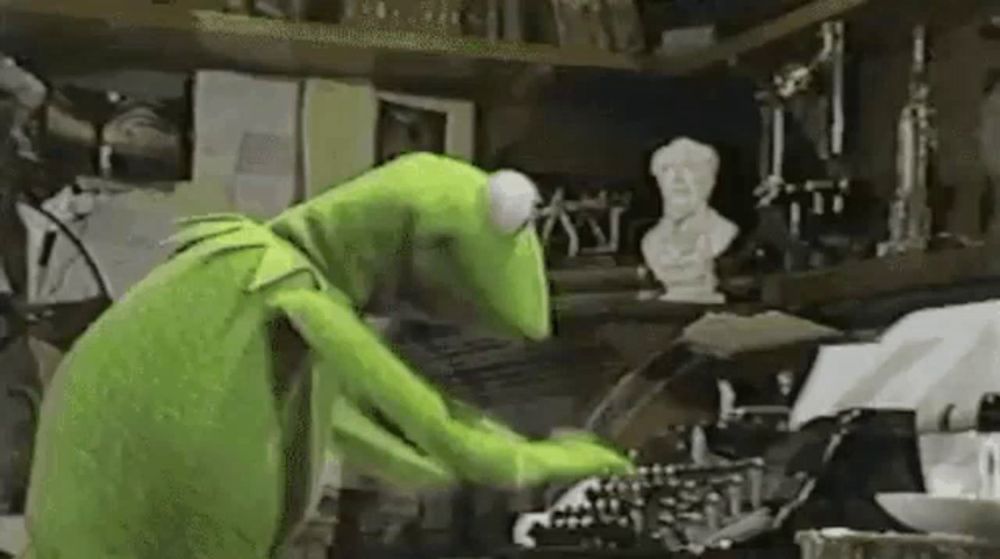 kermit the frog is cleaning a typewriter in a room .