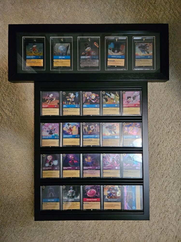 A photo of two frames containing a bunch of trading cards, all based on the 2017 reboot of Ducktales.