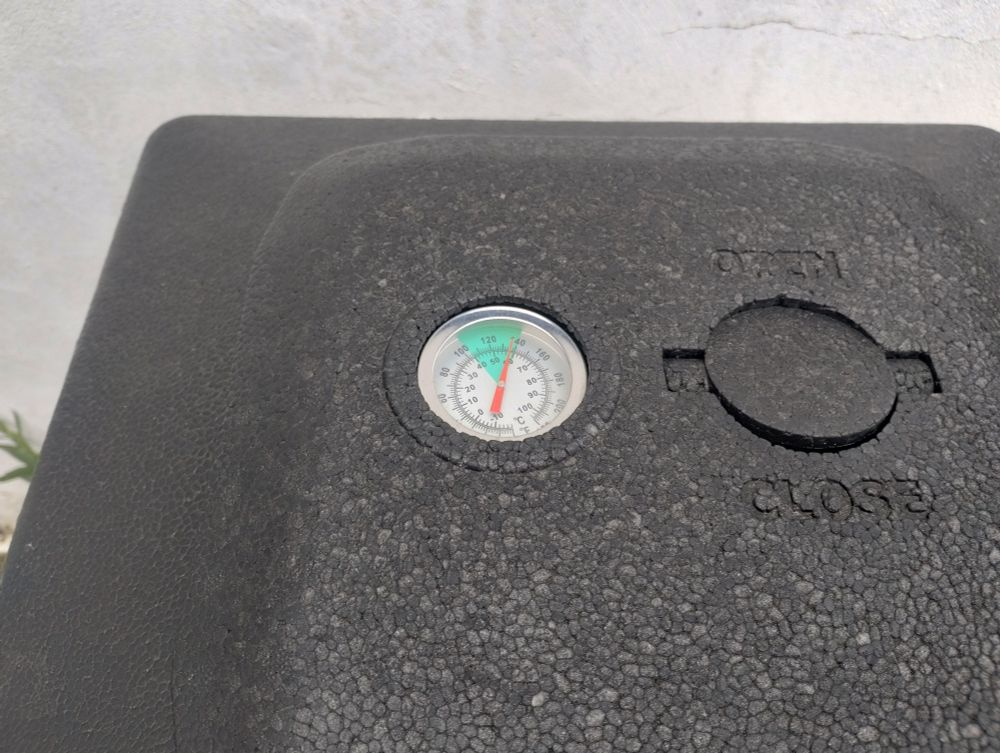 thermometer in the top of a hotbox composter showing the the temp at the top of the green range