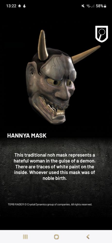 Eine Hannnya Maske aus Holz mit 2 Hörnern ähnlich einem Teufel. Unter dem Bild steht Diese traditionelle Noh Maske zeigt eine rachsüchtige Frau in Gestalt eines Dämons. Auf der Innenseite der Maske sind Reste von weißer Farbe. Wer auch immer diese Maske nutzte war von hoher Geburt. 