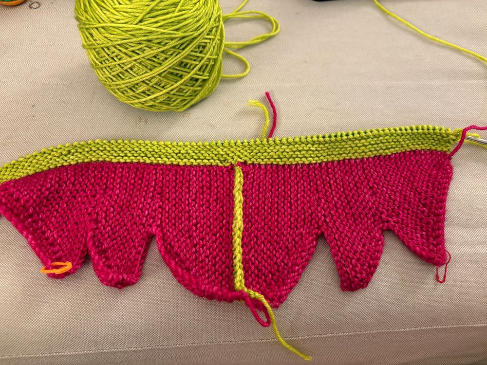 A knitting project in fuschia and apple green 