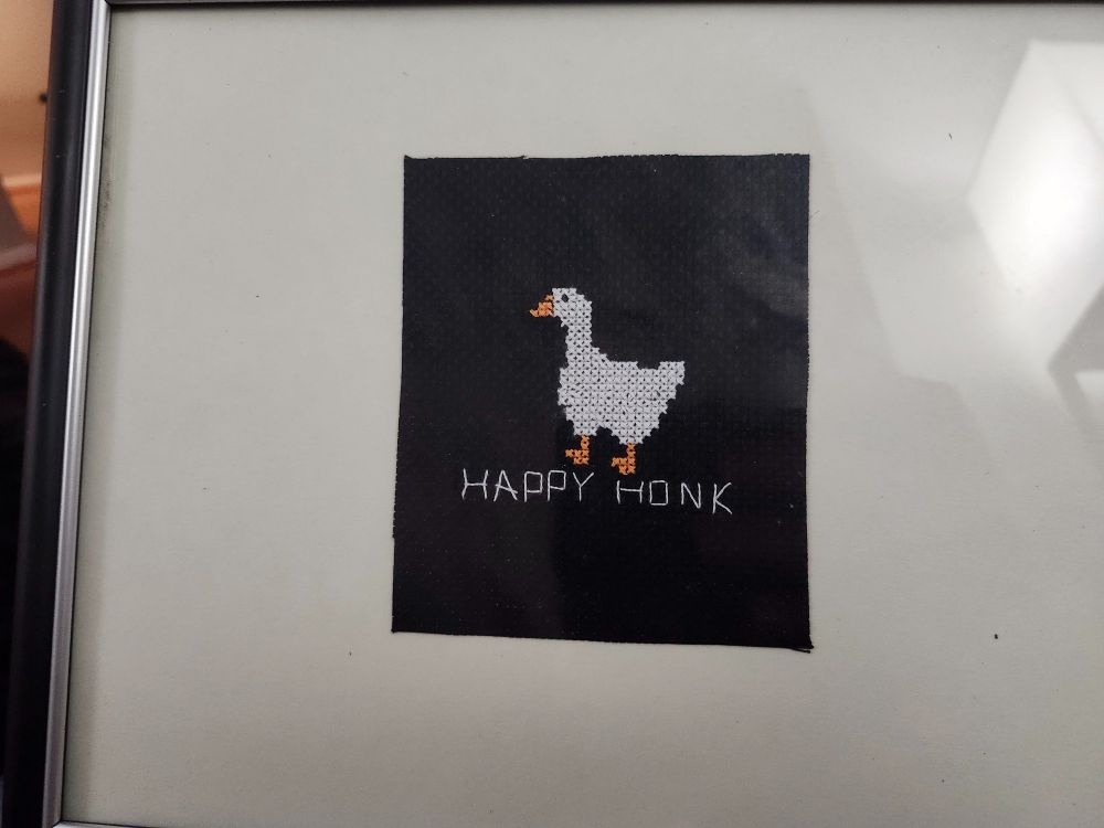 A cross-stitch showing a goose and the caption "Happy Honk"