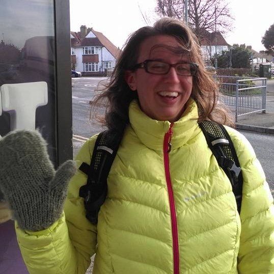A photo of me from some years back. I'm waving, while wearing a fluorescent yellow puffa jacket.