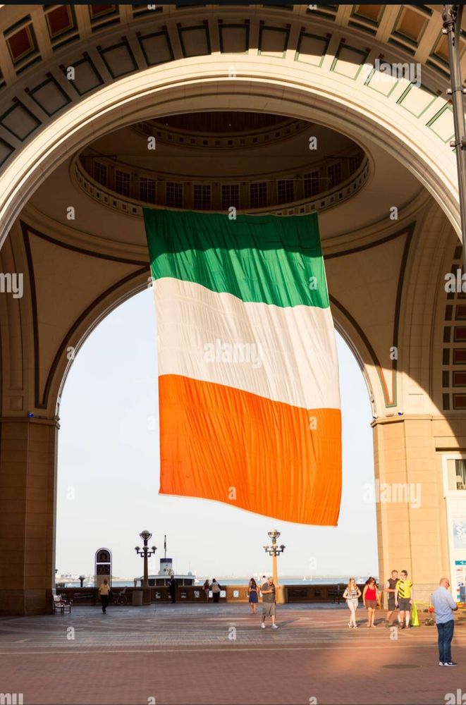 Large Irish flag hanging from a municipal building in Boston. 