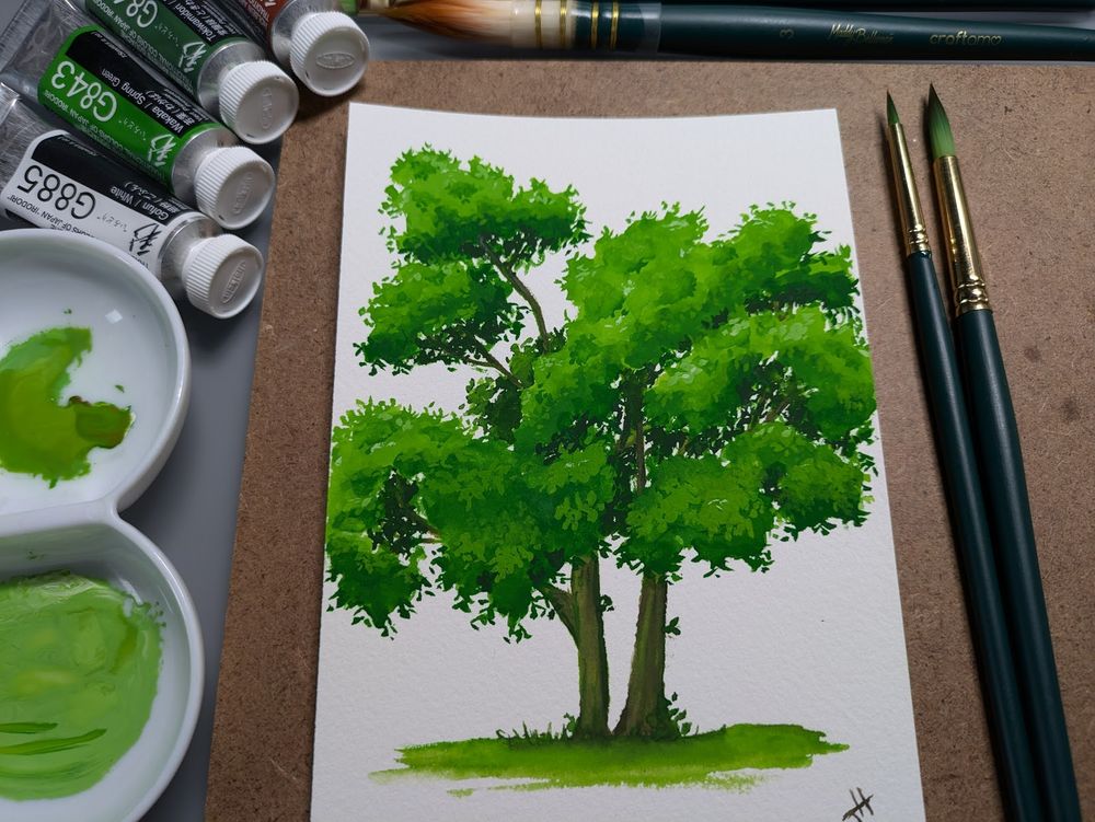 Gouache painting of a tree on scrap paper with rich greens