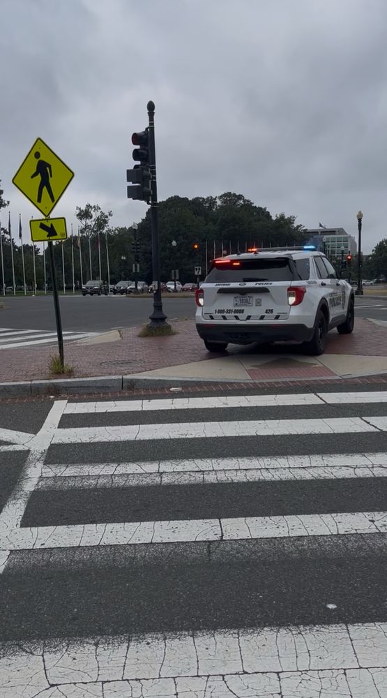 Amtrak Police SUV with lights but zero officers, running but parked on a pedestrian island outside Union Station blocking the way of any pedestrians with mobility restrictions and polluting the air.
