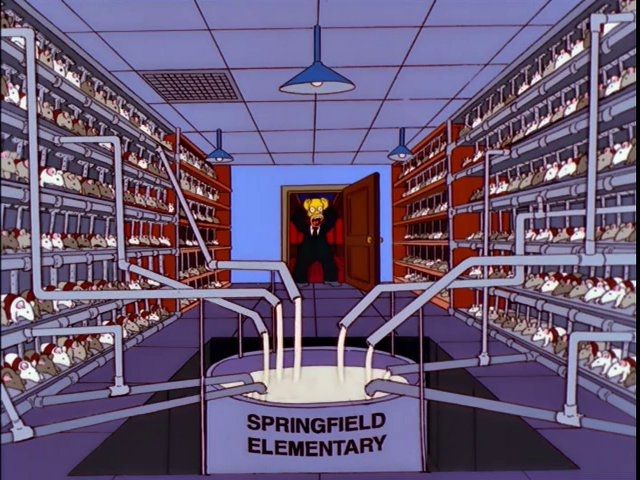 A screenshot from the Simpsons in which Homer Simpson is looking shocked in a room where shelves of rats are being milked into a giant vat of milk in the center of the room that says "Springfield Elementary" 