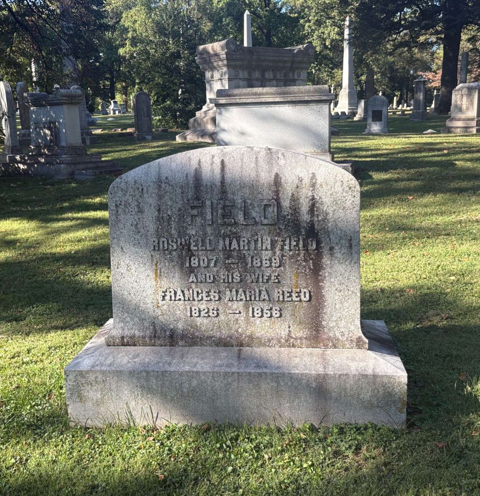 A wide gravestone with a rounded top
