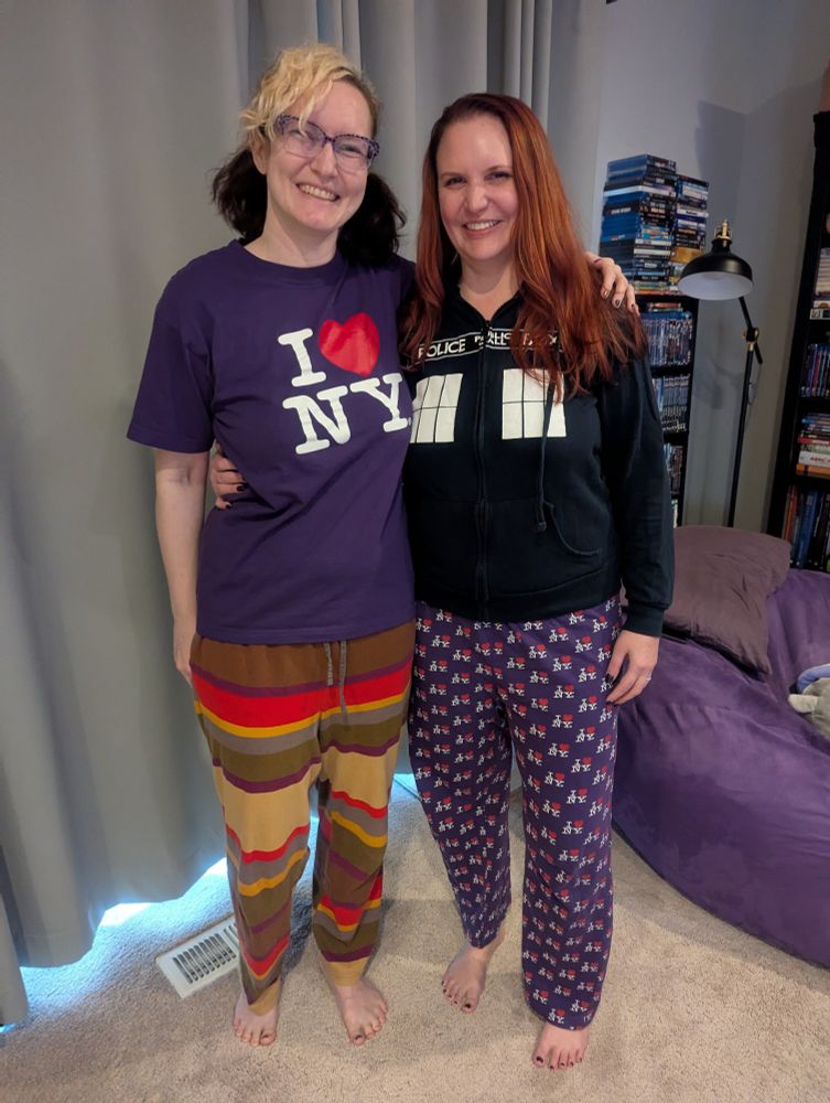 Rose in a purple I Heart NY T-shirt and Doctor Who 4th Doctor pajama pants, and Lorelei in a Doctor Who TARDIS hoodie and purple I Heart NY pajama pants