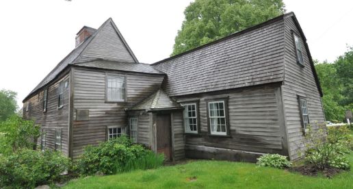 view of what looks to be two staggered, two-story, attached gray buildings, shingles on the sides and roofs, lots of gables. looks a lot like a place that has ghosts.