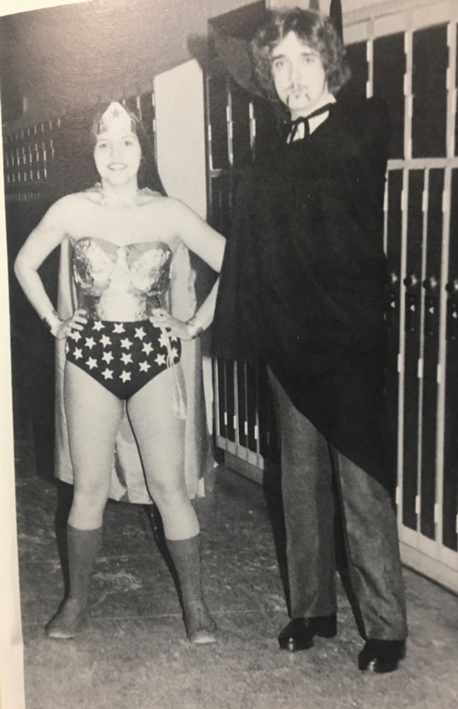 Teens dressed for Halloween as Wonder Woman and Dracula.