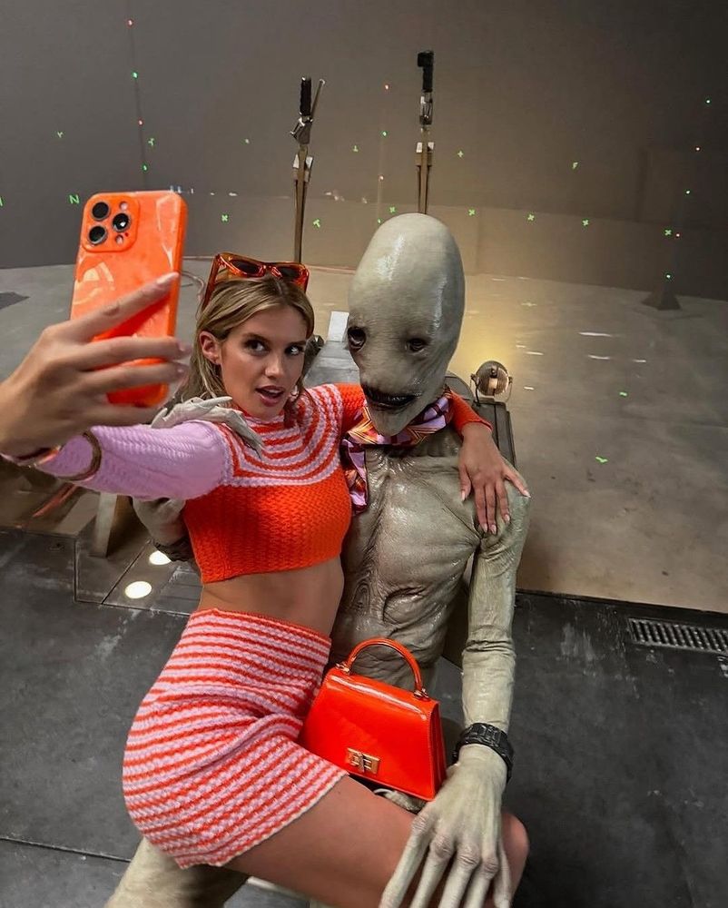 Girl taking selfie with alien