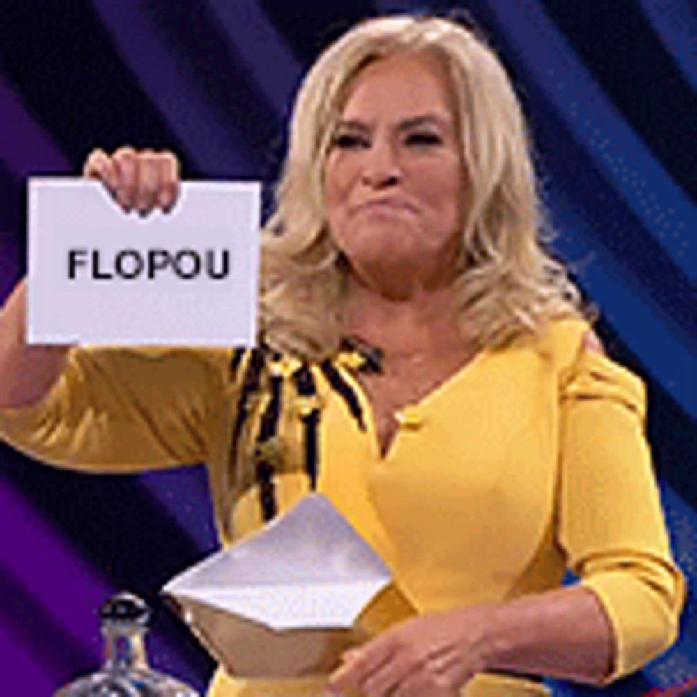 a woman in a yellow dress is holding a piece of paper with the word flopou on it .