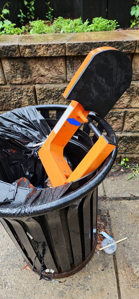 A parking boot in a trash can, but from the other side