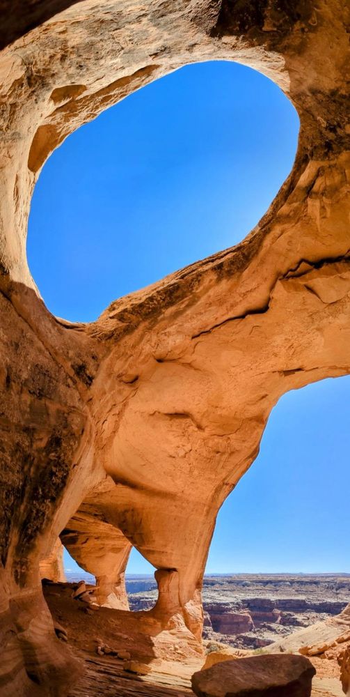 A vertical image of a cave in southeast Utah with four arches shown in the frame. 