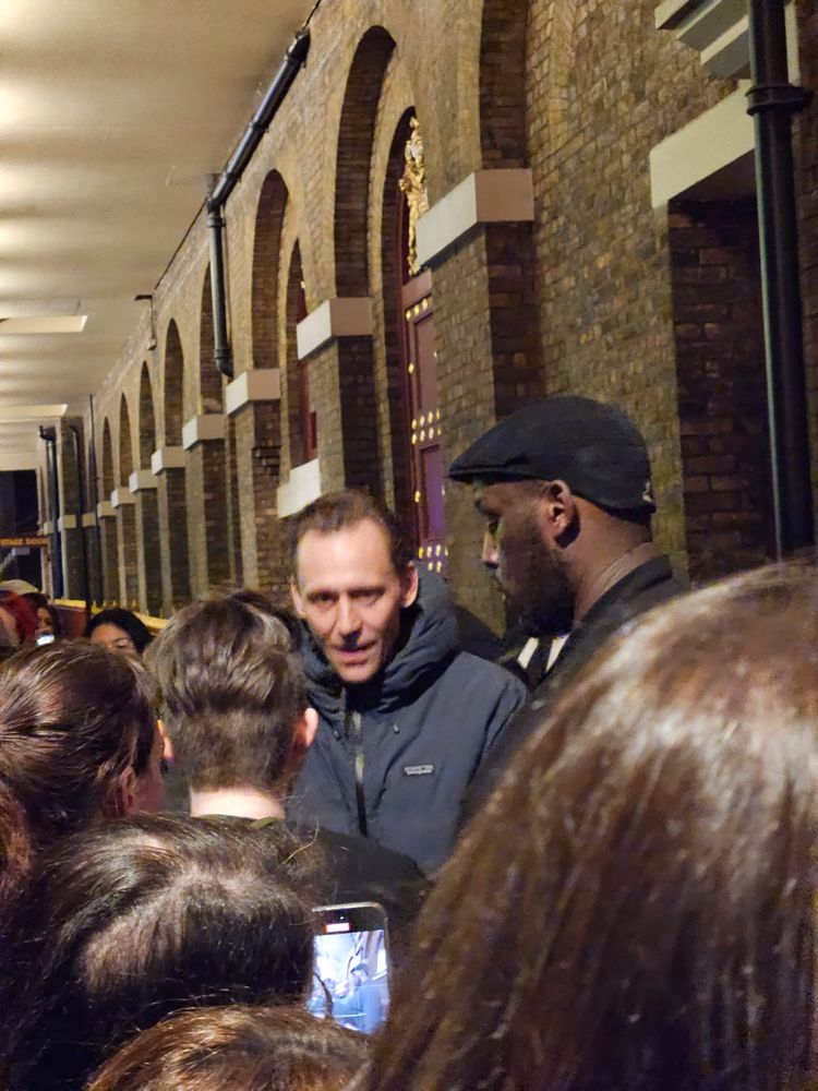 Tom Hiddleston in the crowd signing theatre programmes