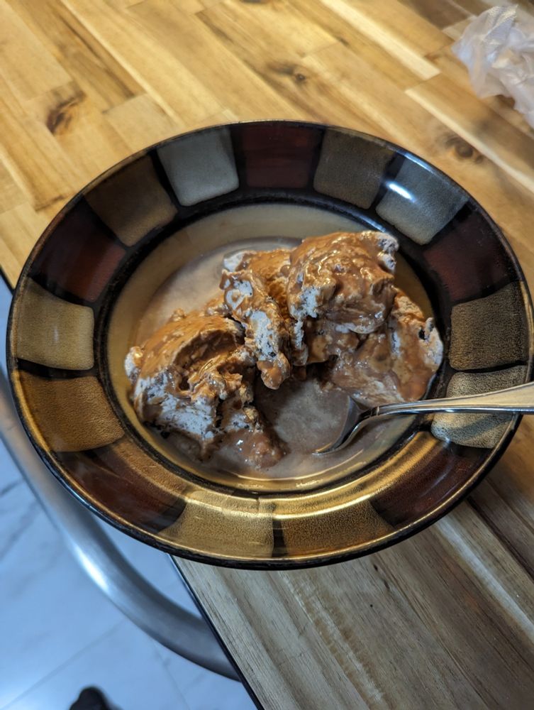 A bowl of Oreo ice cream with chilled coffee poured over it.
