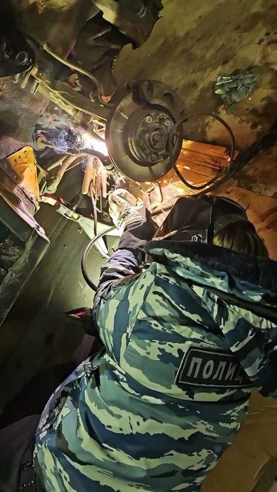 me laying on my side under a car welding