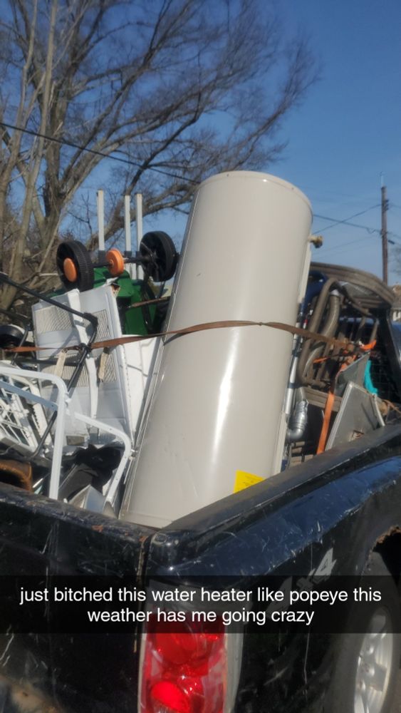 bed of black dodge dakota full of assorted scrap, text saying "just bitched this water heater like Popeye this weather has me going crazy"