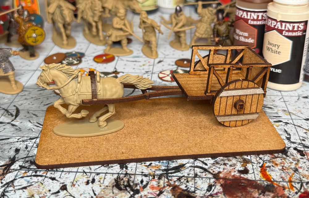 A two-wheel dark ages cart made from MDF, being pulled by a plastic horse