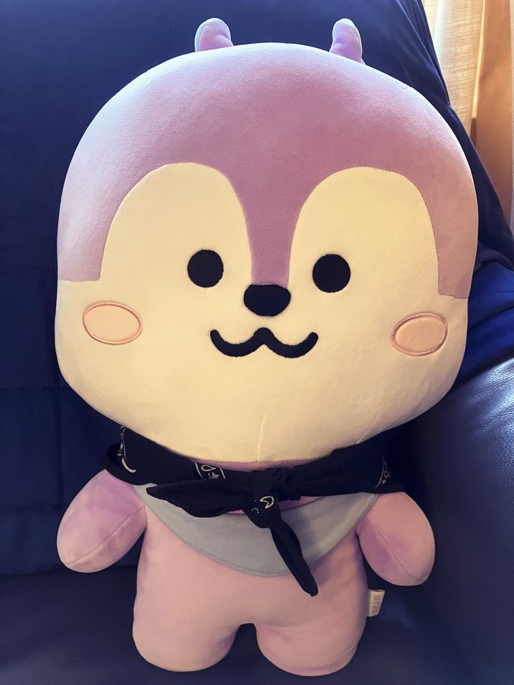 large squishy plushie of Mang from BT21 wearing a fashionable neckerchief. 