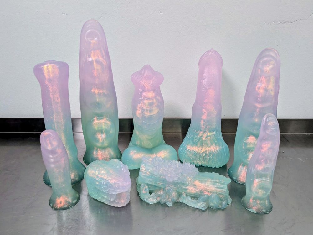 A batch of fantasy toys in a purple to aqua fade with rainbow colorshift 