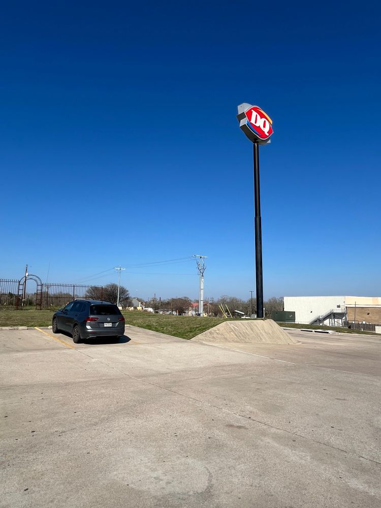 Dairy Queen sign against a blue central Texas sky