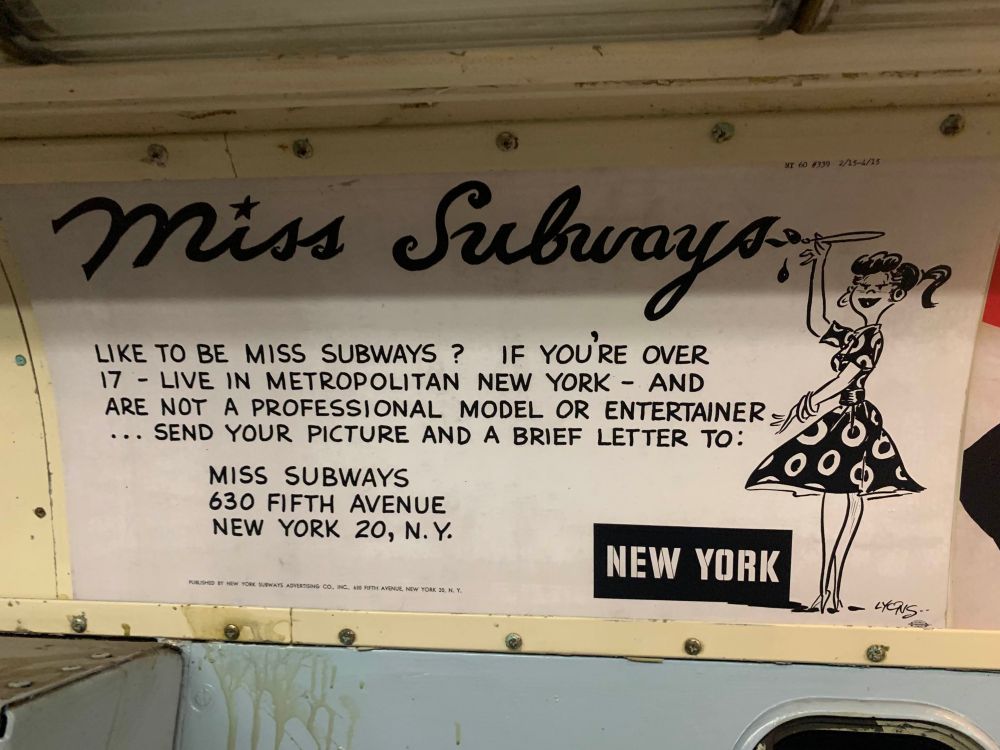 A vintage advertisement on a New York City subway car in the NY Transit Museum. It reads: "MISS SUBWAYS. Like to be Miss Subways? If you're over 17 — live in metropolitan New York — and are not a professional model or entertainer . . . send your picture and a brief letter to: Miss Subways, 630 Fifth Avenue, New York 20, N.Y." with a cartoon of a woman in a patterned dress painting the "MISS SUBWAYS" logo in cursive.