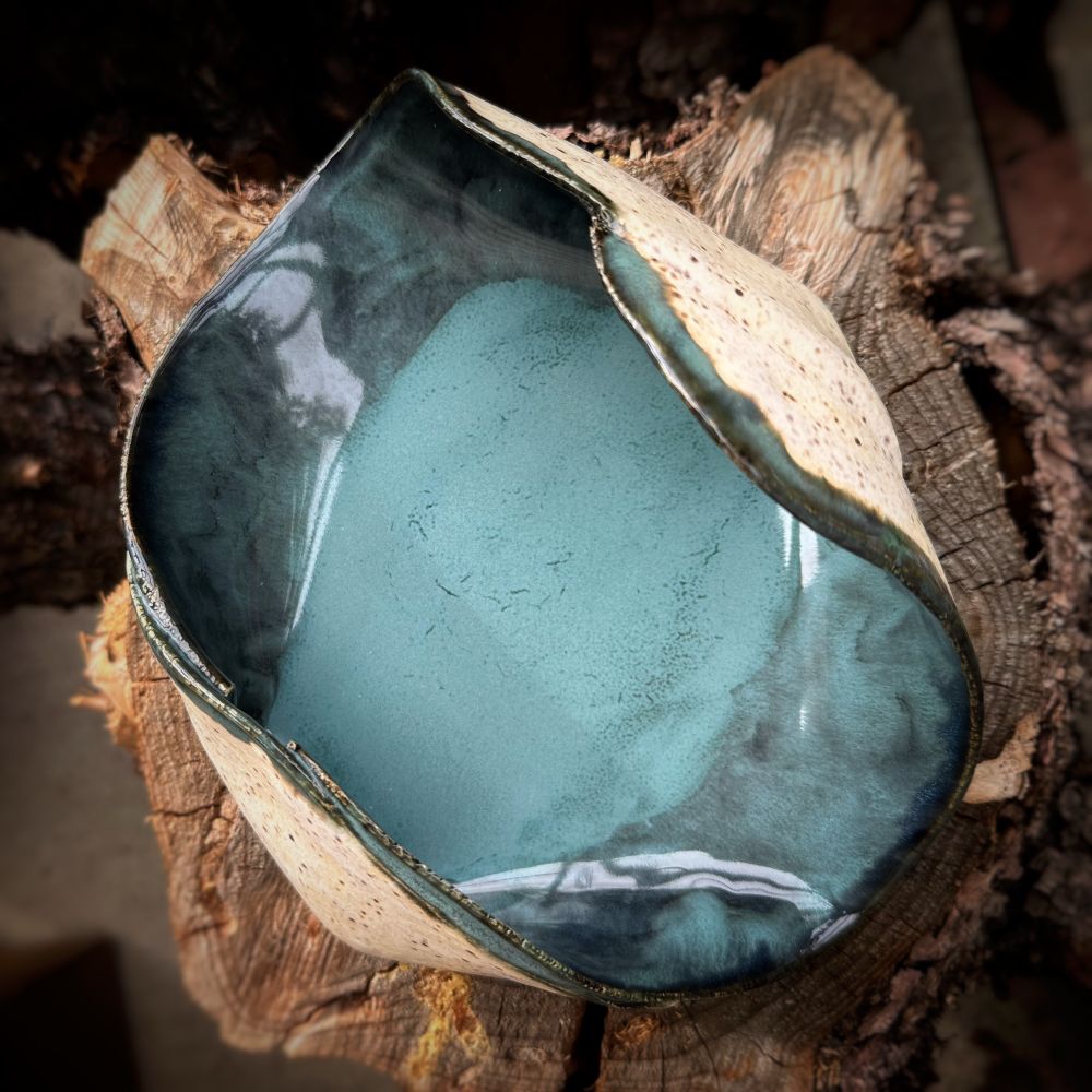 Photo of a ceramic bowl with a turquoise-y blue interior 