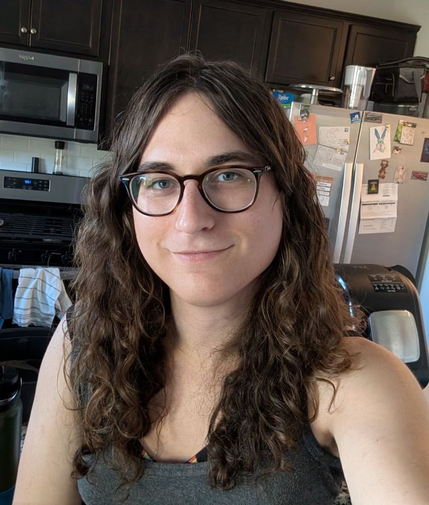 The same girl, two years later, who has now learned to take care of her hair and what this funny little blue pill you put under your tongue does. She's smiling at the camera, and has notably more light behind her eyes. 