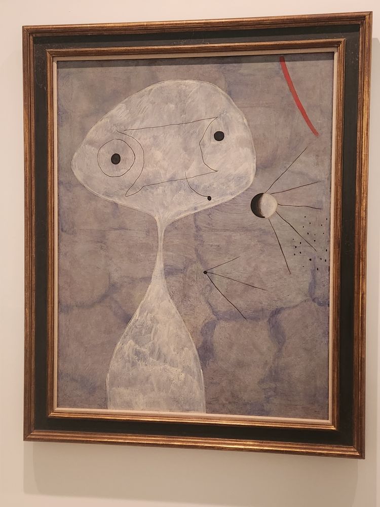 Painting by Joan Miro (He's Spanish, should have an accent on the O)
Painting (Man with a Pipe)

I would classify this as very abstract, but compared to some of his works? This has recognizable shapes!

A gray background with a white shape that is basically a misshapen circle/horizontal oval that flows down through a skinny neck to a white oblong. Rudimentary black lines and dots create the semblance of a face. The pipe is represented by a white circle with 3-dish black shadowing and black lines emanating from it on the gray field, somewhat resembling a pipe with straight lines of smoke. If you know that's what the painting is called. Sure. 

In the top right, there is a swoop-y line of red. What does that represent? No clue. 

But! It is freaking Joan Miro and I saw it in person! How cool is that?!