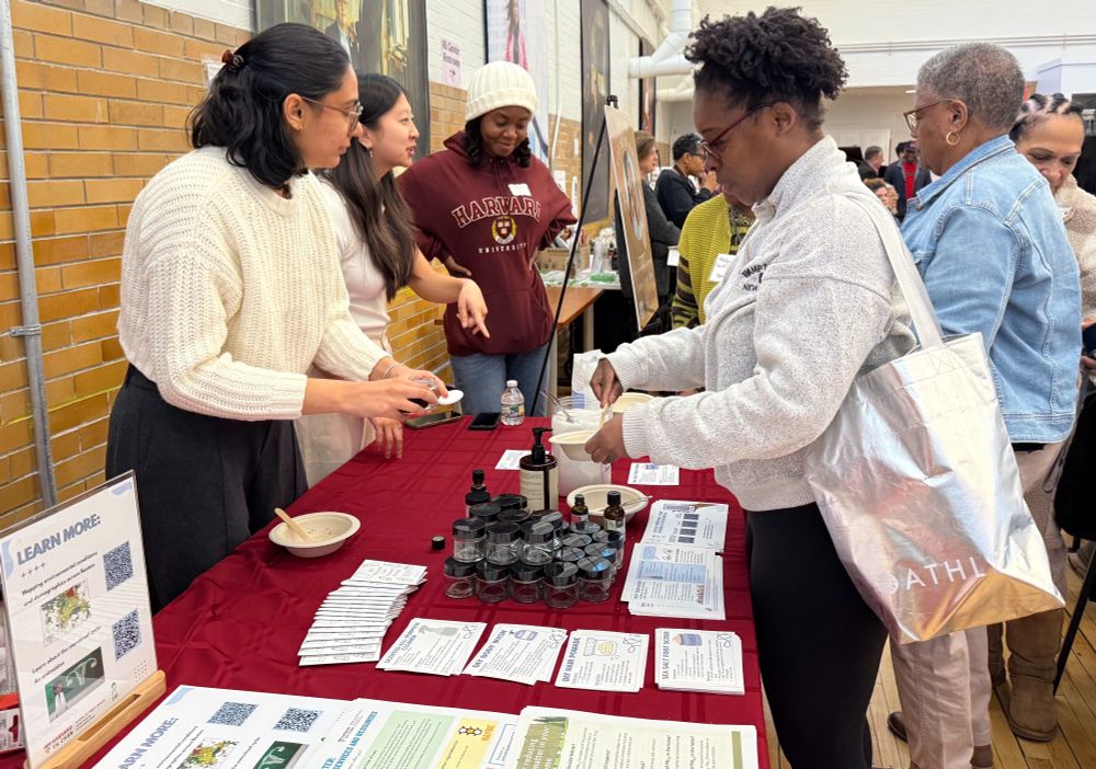 At the Harvard Chan NIEHS Center table, EH students and research assistants demonstrate how to make a natural DIY foot scrub.