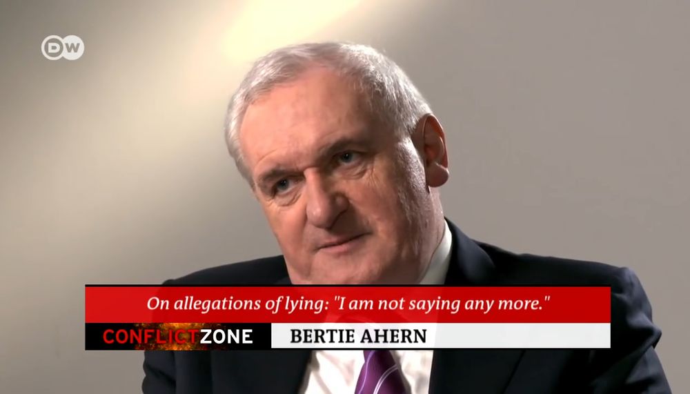 Image (from an interview on DW) of unimpressed, former Irish head of government, Bertie Ahern. A caption box within reads "On allegations of lying: "I am not saying any more." Conflict Zone. Bertie Ahern" 