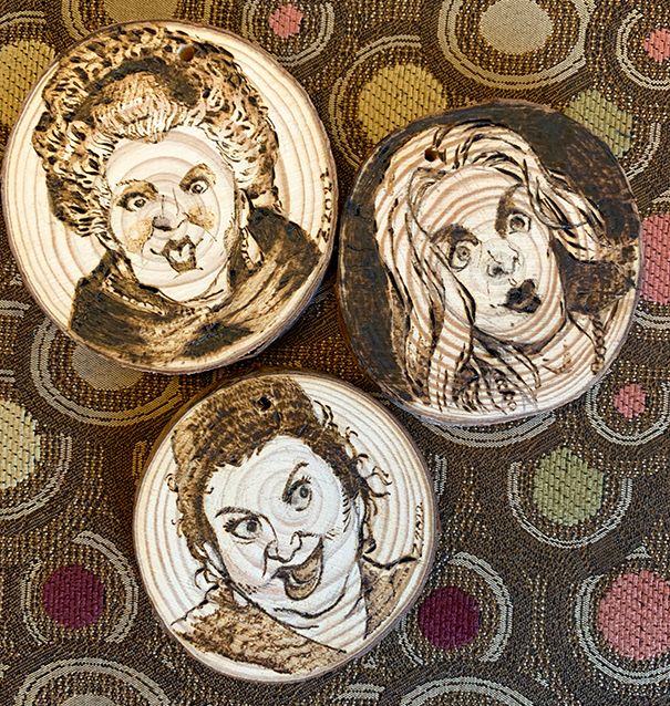 Wood burning portraits of the Sanderson sisters from the movie Hocus Pocus on wooden ornament disks.